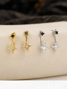 Macro detail of S925 silver star stud earrings with zirconia stones and enamel finish