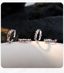 Macro shot of silver lava rings with red and pink enamel on a minimalist display