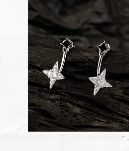 Macro detail of S925 silver double star earrings with black enamel and zircon stones