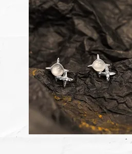 Macro shot of S925 sterling silver star stud earrings with white agate and zircon stones