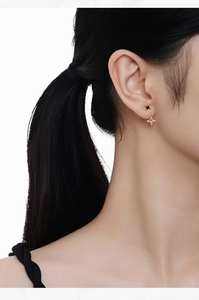 Detailed close-up of S925 silver star stud earrings worn on model's ear