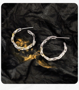 Detailed view of S925 sterling silver chain link hoop earrings with hallmark engraving