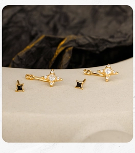 Detail of S925 silver star earrings with black enamel and sparkling zircon accents