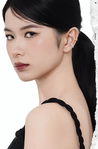 Close-up of gold and silver S925 sterling silver ear cuffs with pavé-set sparkling crystals