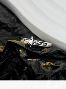 Macro detail of vintage S925 silver ring with starburst centerpiece and CZ leaf pattern