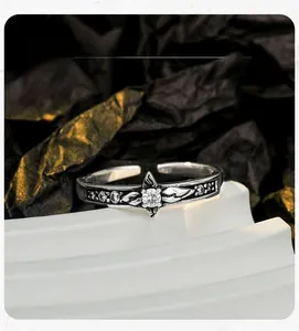 Macro shot of vintage S925 sterling silver ring featuring starburst petals and engraving