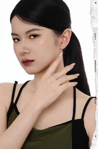 Detail showing an S925 silver ring with marquise-cut stones worn on a model hand