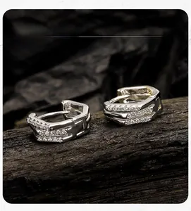 Detail view of S925 sterling silver hoop earrings with triple row zircon inlay