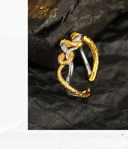 Macro shot of S925 sterling silver snake ring with gold accents and micro-set zircon