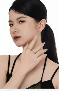 Close-up of S925 sterling silver pearl earrings and ring set on female model