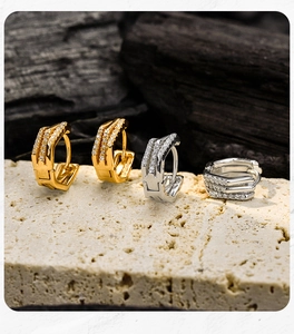 Detailed view of gold and silver S925 sterling silver geometric earrings with pavé crystals
