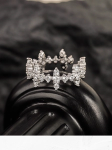 Macro shot of S925 sterling silver ring with pavé-set sparkling zircons in crown design