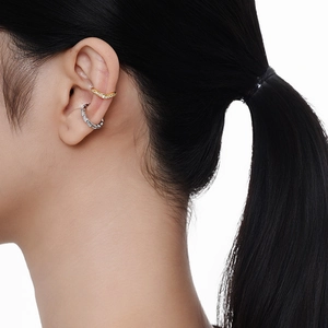 Elegant gold and silver geometric ear cuff set with pavé crystals on a female model