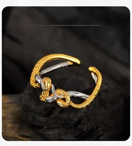 Macro detail of a bicolor snake ring with scale texture and shimmering zircon inlay