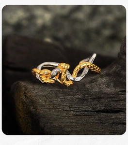 Macro shot of two-tone intertwined snake rings with sparkling zircon inlay details