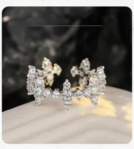 Macro detail of S925 silver cross ring with sparkling pavé cubic zirconia crystals