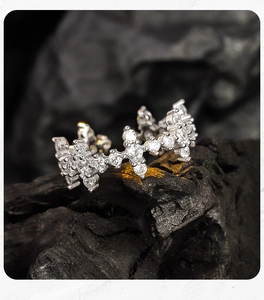 Macro shot of sparkling S925 silver cross ring with pavé zircons on rustic stone