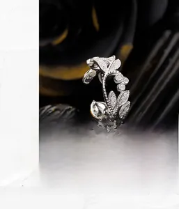 Macro shot of silver leaf ring with hollow design and sparkling crystal pavé setting