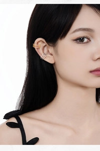 Detail of gold and silver triple-layered ear cuffs with micro-pave white zircons