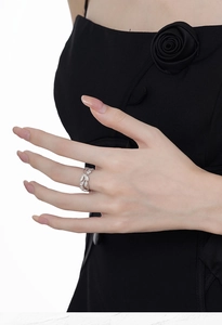 Detail of S925 sterling silver leaf ring with pavé diamonds worn on finger