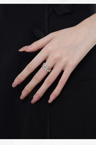 Detailed view of S925 sterling silver hollow leaf ring with pavé diamonds on finger