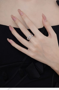 Close-up of S925 sterling silver leaf ring with pavé diamonds on a model's finger