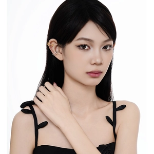 Three-layer geometric gold cuff and silver zircon hoop earrings on a female model
