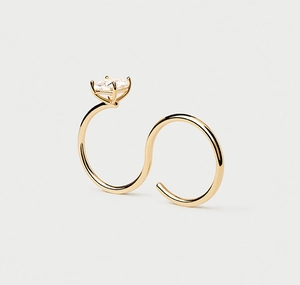 Detail view of gold S-shaped bypass ring with emerald cut cubic zirconia stone