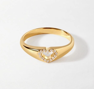 Detailed macro view of gold-plated hollow heart ring set with shimmering zircon stones