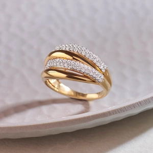 Macro detail of multi-layer gold S925 silver ring with crisscross pavé zircon settings