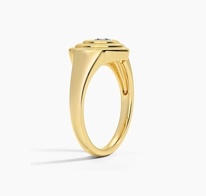 Macro shot of gold-plated signet ring with tiered structure and a single sparkling gem