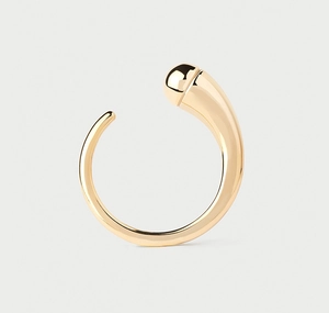 Close-up of a minimalist gold teardrop open ring with a polished metallic finish