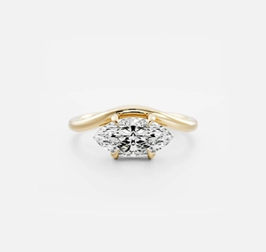 Macro shot of a marquise cut zircon gemstone on a wavy 18K gold plated silver band