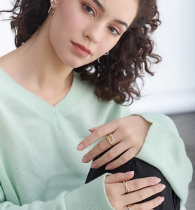 Detail of multi-layer silver ring with sparkling zircons on model's hand