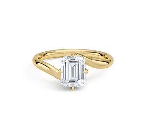 Macro detail of emerald cut zircon on a gold bypass ring with four-prong setting