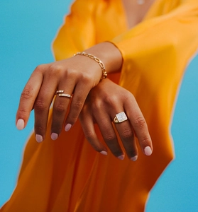 Detailed view of S925 silver gold rings with rectangular zircon on orange silk