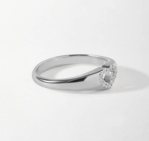 Macro shot of silver S925 heart ring with hollow center and sparkling diamond pave detail