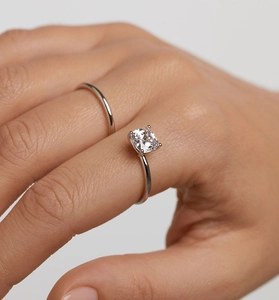 Macro view of S925 sterling silver S-shape ring with a square-cut diamond on model hand
