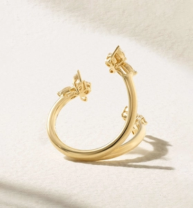 Detailed view of a gold bypass ring featuring sparkling zircon butterfly and flower motifs