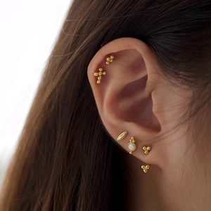 Set of minimalist S925 sterling silver gold earrings with opal stones on a model ear