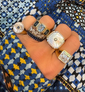 Close-up of stacked S925 silver rings with rectangle zircon and mother of pearl in gold finish