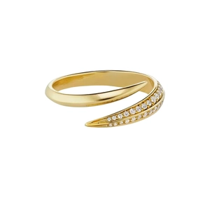 Macro shot of gold claw-shaped ring with pave-set zircon stones on white background