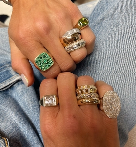 Macro shot of layered S925 sterling silver rings with emerald and zircon stones