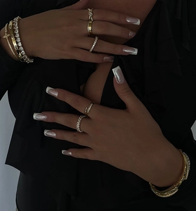 Detail of stacked gold vermeil rings and bracelets featuring twisted band and pavé stones