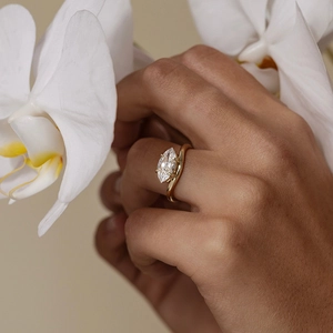 Elegant gold S925 silver ring featuring a marquise-cut zircon stone on a twisted band