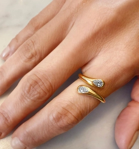 Detailed macro shot of an adjustable gold-plated double teardrop ring with pavé zircons