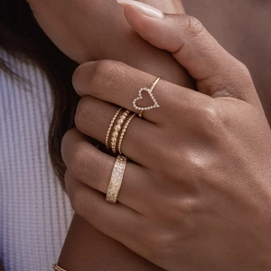 Elegant gold S925 silver ring set with hollow heart and diamonds on a model hand