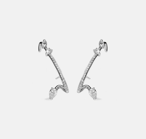 Detailed macro view of S925 sterling silver ear crawlers with pear-cut zircon stones