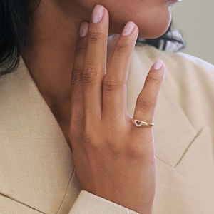 Elegant gold openwork heart ring with pavé diamonds on a female model finger