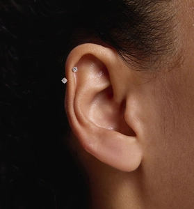 Macro shot of S925 sterling silver U-shaped ear studs featuring round-cut cubic zirconia